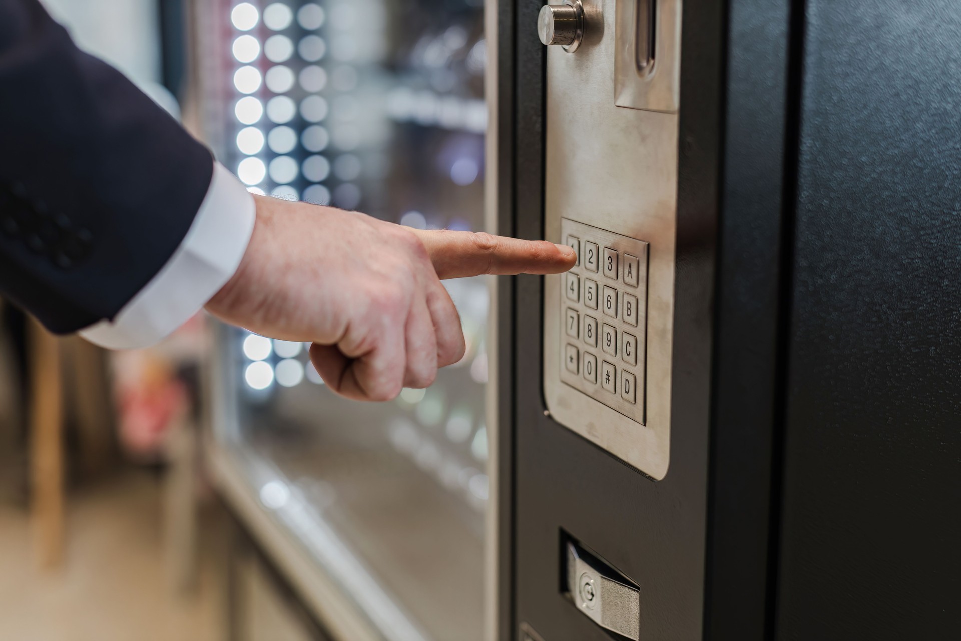 Hand man use of soft drink vending system. Man use drink coin machine at smart office or Public park. People use  Vending Machine, is robotic for the high-quality drink