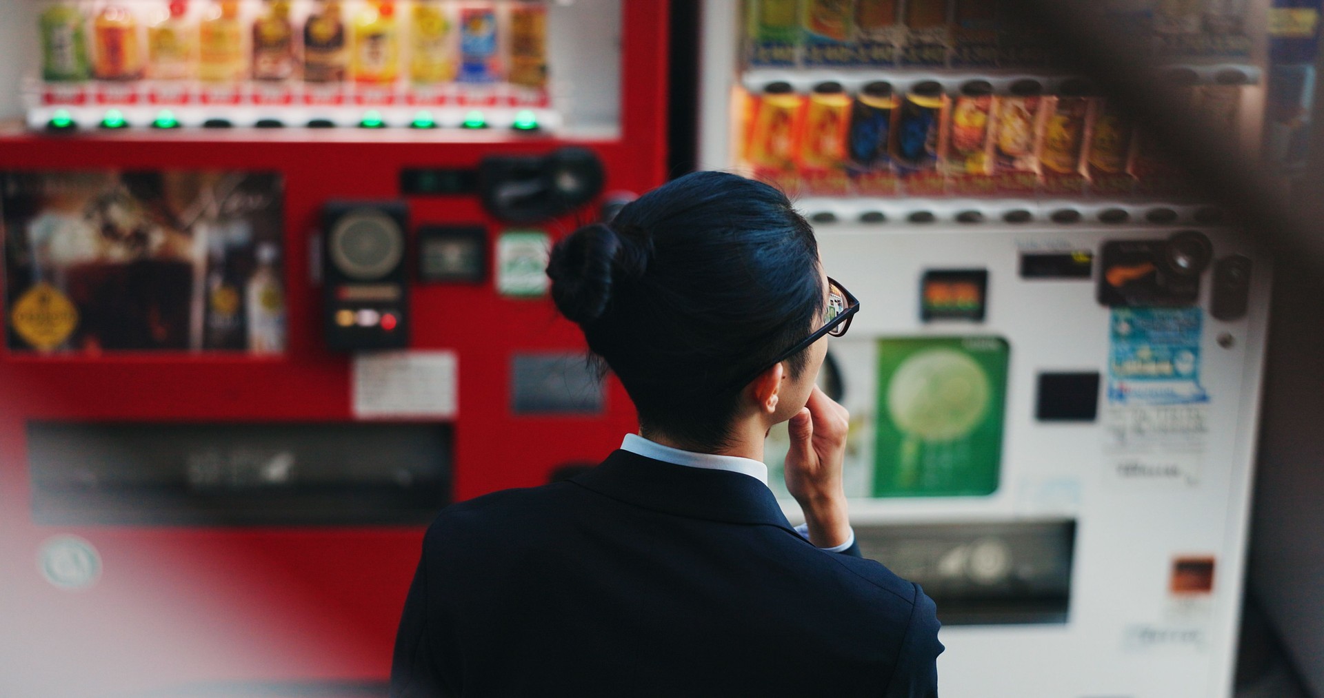 Vending machine, business man and thinking, decision or choice of automatic service on digital tech at night in city outdoor. Back, shopping and professional customer in urban town in Tokyo Japan