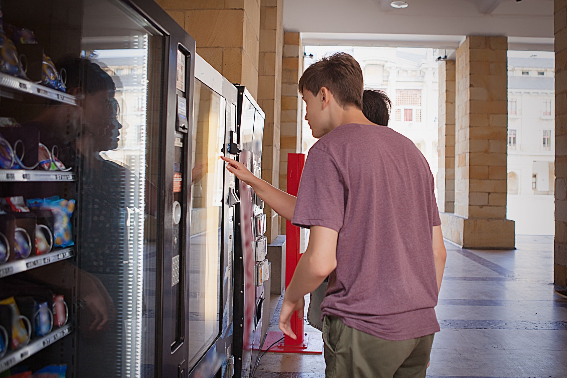 Mother and son in front of a vending machine